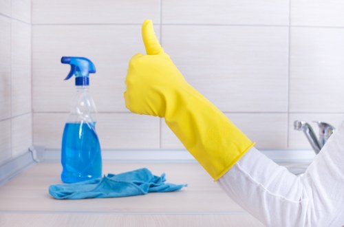 Local cleaner treating stains on a corner sofa in E9